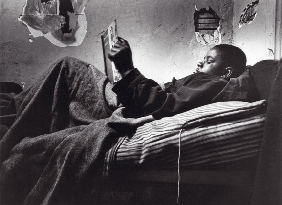 Norman Jr. Reading in Bed, 1967. Photo by Gordon Parks