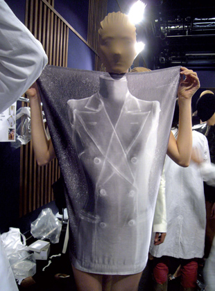 SS 2009 Women's show backstage, Negative photograph of the first jacket (SS1989) printed on silk satin affixed to the body and held as a "poster-dress". Copyright Marina Faust/Maison Martin Margiela